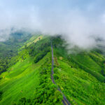 Aerial view of Beautiful sky road over top of mountains with green jungle in Nan province, Thailand.